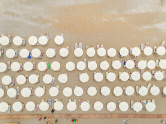 Aerial view of beach of Rhodes island with white parasols in line, Greece. - AAEF00185
