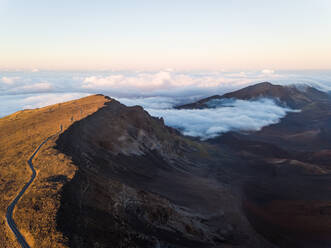 Luftaufnahme einer Straße, die bei Sonnenuntergang einen hohen Berg überquert, Hawaii, U.S.A. - AAEF00404