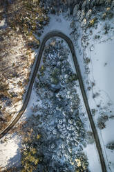 Aerial view of an empty road surrounded by snow - AAEF00441