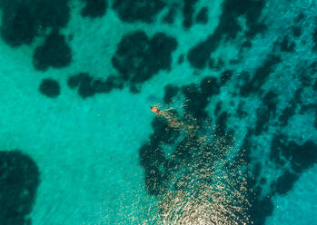 Aerial view of woman swimming with flippers in the sea of Maganisi island, Greece - AAEF00499