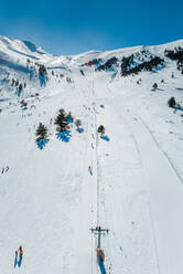 Aerial view of people trekking at snow-covered Mount Erymanthos in Greece - AAEF00565