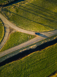 Aerial view of a car on the road in the countryside of Vinkeveen in the Netherlands. - AAEF00683