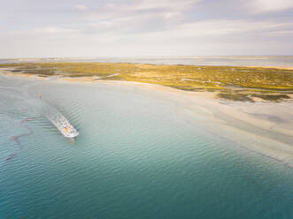 Aerial view of a boat navigating in the Formosa Lagoon in Portugal - AAEF00824