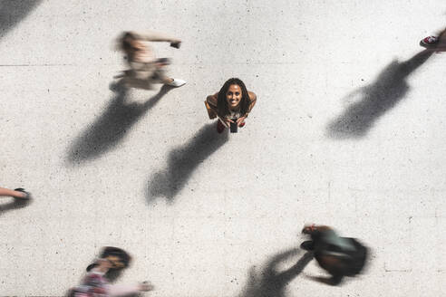 Portrait of happy young woman looking up, top view - WPEF01705