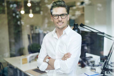 Portrait of smiling businessman in office - PNEF01798