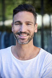 Portrait of smiling mature man outdoors - PNEF01847