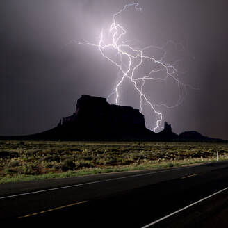 Kompositfoto eines Blitzeinschlags hinter Eagle Mesa am Highway 163 im Jahr 2016, in der Nähe von Monument Valley, Utah, Vereinigte Staaten von Amerika, Nordamerika - RHPLF00167