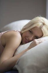 Caucasian woman laying in bed - BLEF13749