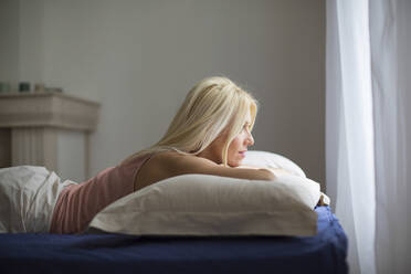 Caucasian woman laying in bed - BLEF13750