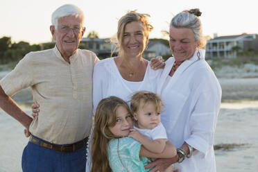 Caucasian family smiling on beach - BLEF13761