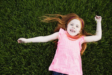 Caucasian girl laying in grass - BLEF13766