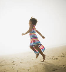 Black girl playing on beach - BLEF13787