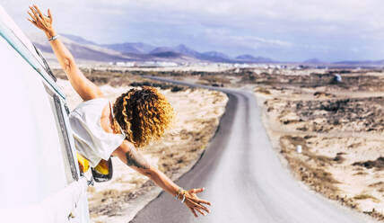 Woman leaning out the window of a van, Fuerteventura - SIPF02079