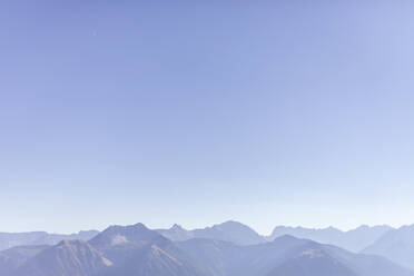 Scenic view of Karwendel mountains against clear blue sky during foggy weather, Bavaria, Germany - MMAF01105