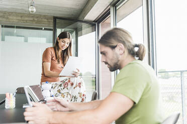 Young businesswoman and businessman working in office - UUF18503