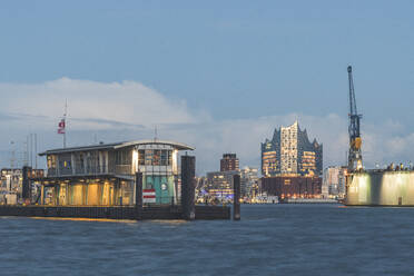 Illuminated Elbphilharmonie by Elbe River against sky in Hamburg, Germany - KEBF01280