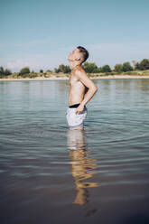 Young man standing in a lake - ACPF00575