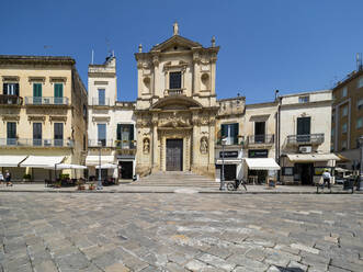 Blick auf eine alte Kirche und Gebäude gegen einen klaren blauen Himmel in der Altstadt von Lecce, Italien - AMF07256