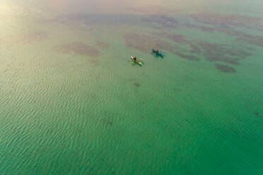 Aerial view of two men in traditional outrigger boats, Dauis, Philippines. - AAEF01160