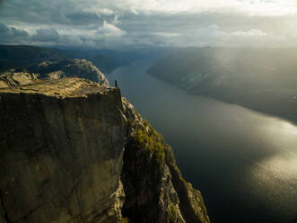 Aerial view of a man standing at Preikestolen, Fossmork, Norway - AAEF01208