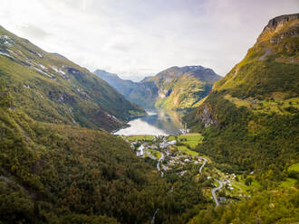 Aerial view of Geiranger village surrounding by tall mountains, Norway. - AAEF01263