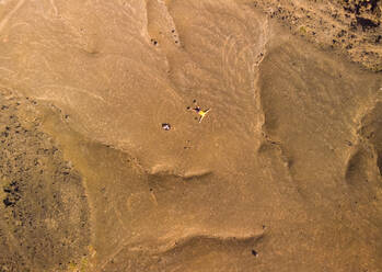 Luftaufnahme eines Mannes, der sich auf eine Felsformation legt, Spanien. - AAEF01290