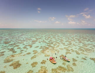 Aerial view of people swimming and eating on Jangadas, traditional small fishing boats in Rio do Fogo, Brazil. - AAEF01468