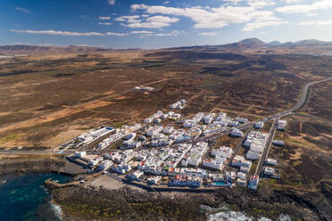 Aerial view of a coastal village in Canary island archipelago with traditional white houses, Tinajo, Spain. - AAEF01506