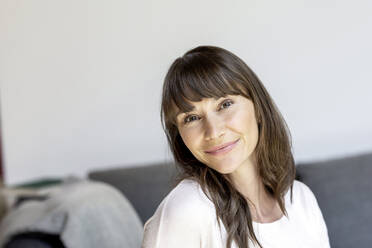 Portrait of smiling woman at home - FMKF05831