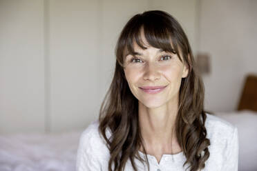 Portrait of smiling woman at home - FMKF05854