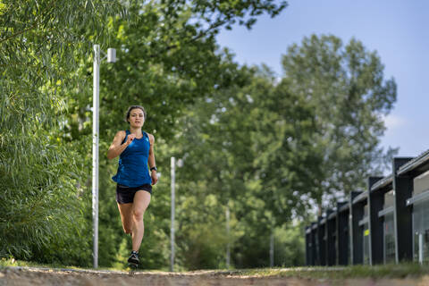 Young woman jogging on a woodchip trail stock photo