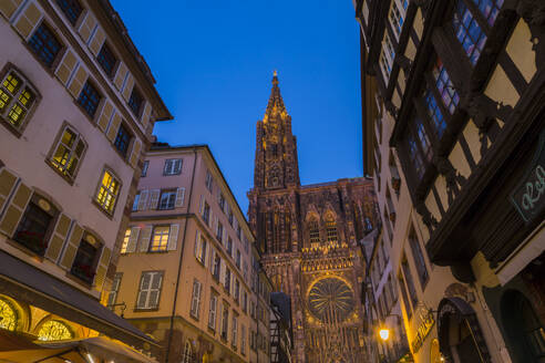 Low angle view of buildings and Notre Dame de Strasbourg against clear blue sky at sunset, France - JUNF01726