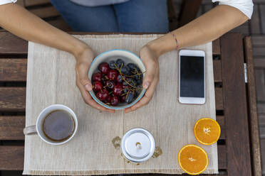 Top view of woman holding fruit bowl - AFVF03752