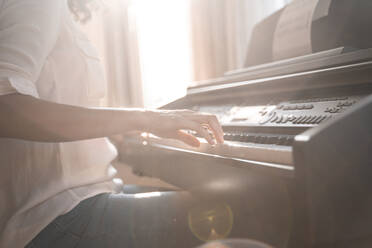 Close-up of woman playing piano - AFVF03774