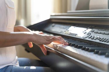 Close-up of woman playing piano - AFVF03776