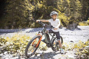 Junge in den Bergen mit seinem E-Mountainbike - FKF03536