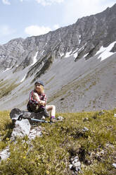 Girl having a break during a hike in the mountains - FKF03542