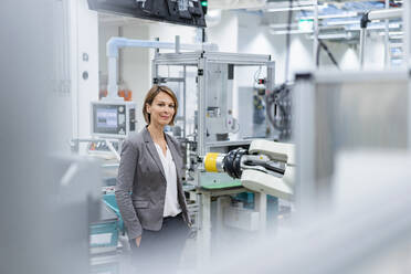 Portrait of a confident businesswoman in a modern factory - DIGF07839