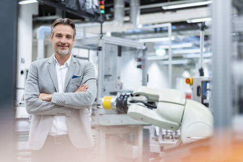 Portrait of a confident businessman in a modern factory - DIGF07842