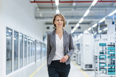 Portrait of a confident businesswoman in a modern factory - DIGF07850