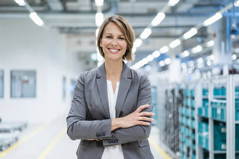 Portrait of a smiling businesswoman in a modern factory stock photo