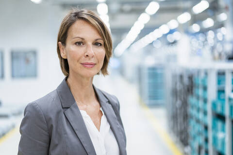 Portrait of a confident businesswoman in a modern factory stock photo