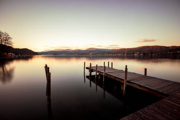 Scenic view of Woerthersee lake against sky during sunset, Austria - DAWF00953