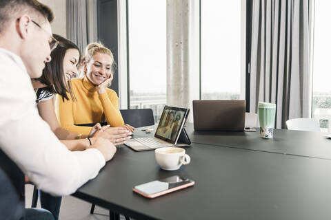 Colleagues having a video conference in conference room stock photo