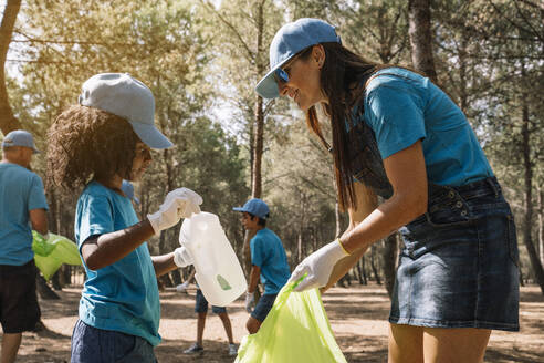 Group of volunteers collecting garbage in a park - JCMF00115