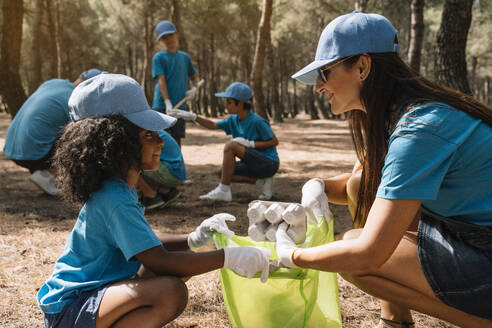 Group of volunteers collecting garbage in a park - JCMF00120