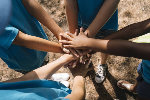 Group of kids stacking hands stock photo