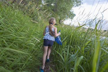 Caucasian girl walking in tall grass - BLEF13881