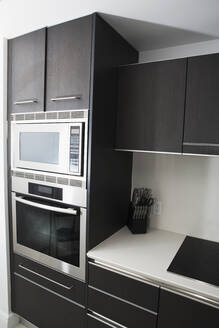 Cabinets, oven and stove in modern kitchen - BLEF13981