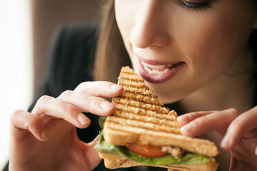 Close up of woman eating sandwich - BLEF14021